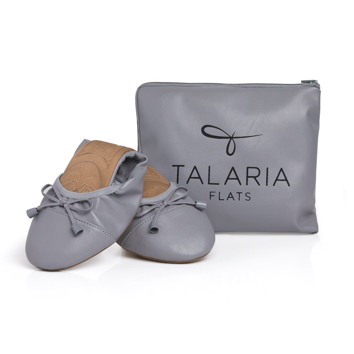 Talaria Flats premium stone grey shoes next to a matching bag, showcasing their stylish and comfortable design.