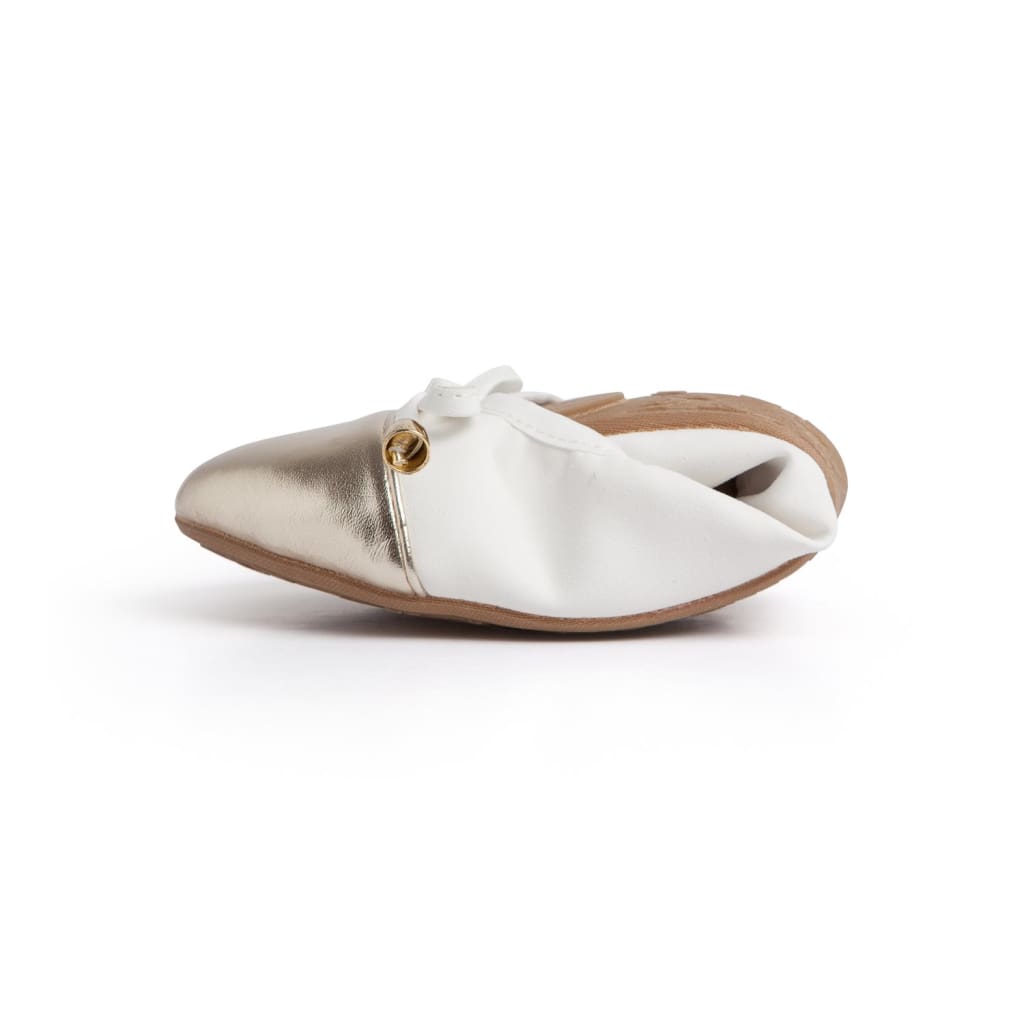 Pair of Talaria Flats premium white shoes with sleek design and comfortable slip-on style, shown on a plain background.