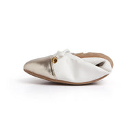 Pair of Talaria Flats premium white shoes with sleek design and comfortable slip-on style, shown on a plain background.