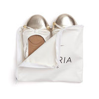 White Talaria Flats shoes, premium white ballet flats with sleek design and comfortable fit, shown from a side angle.
