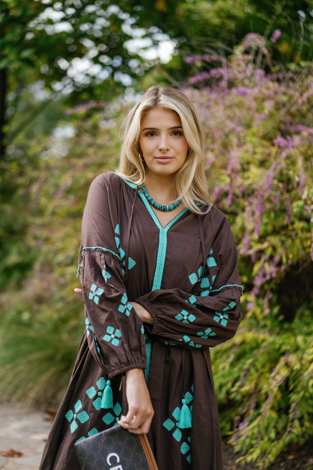 Brown is the New Black teal handbag by Tela Luxury Mercantile, featuring a sleek design and elegant brown and teal color combination.