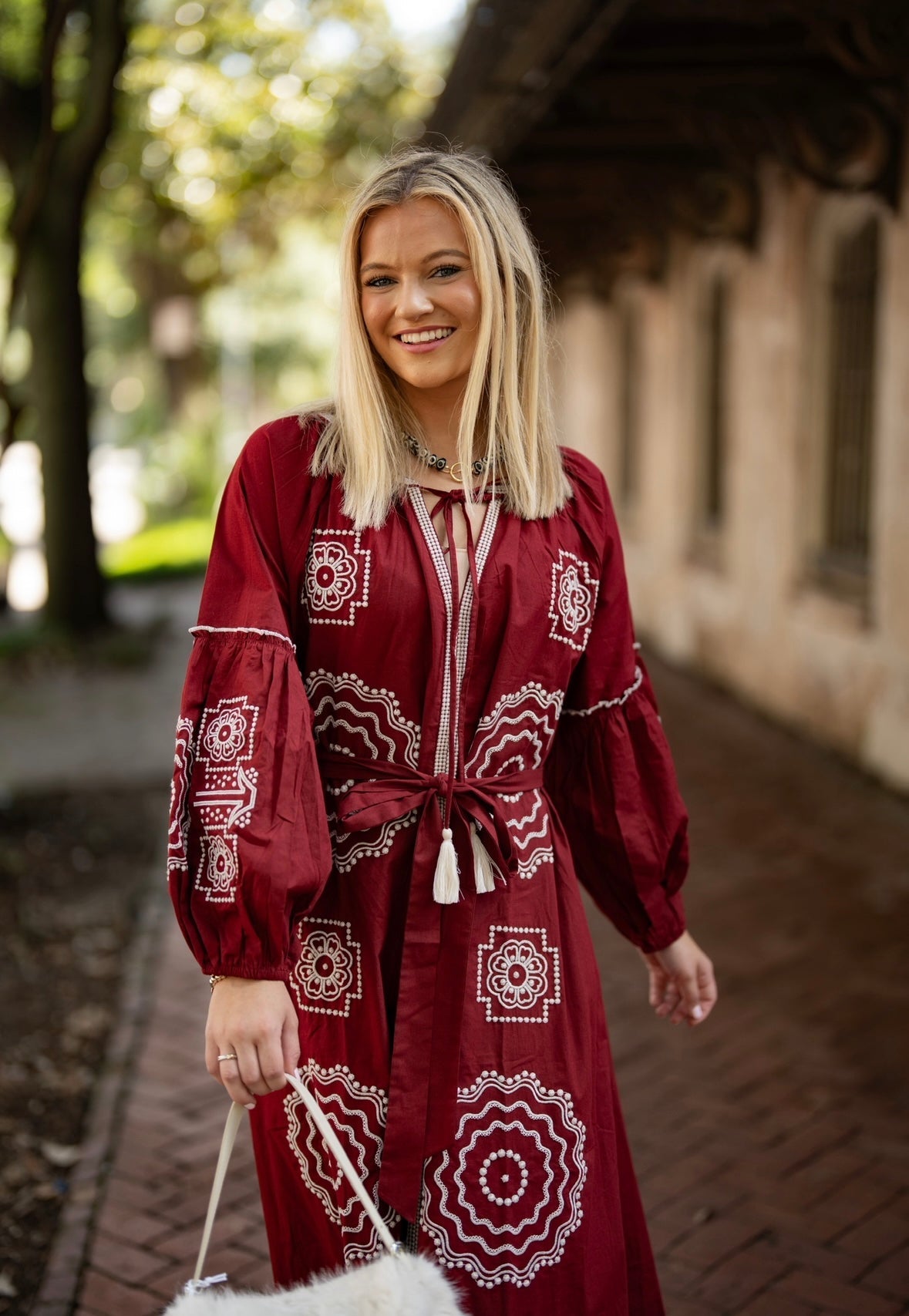 Crimson and white Tela Luxury Mercantile fabric swatch showcasing vibrant color and luxurious texture.