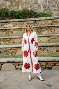 Tela Luxury Mercantile Denny Dress displayed on a hanger, featuring a stylish, flowing design with a soft fabric appearance.