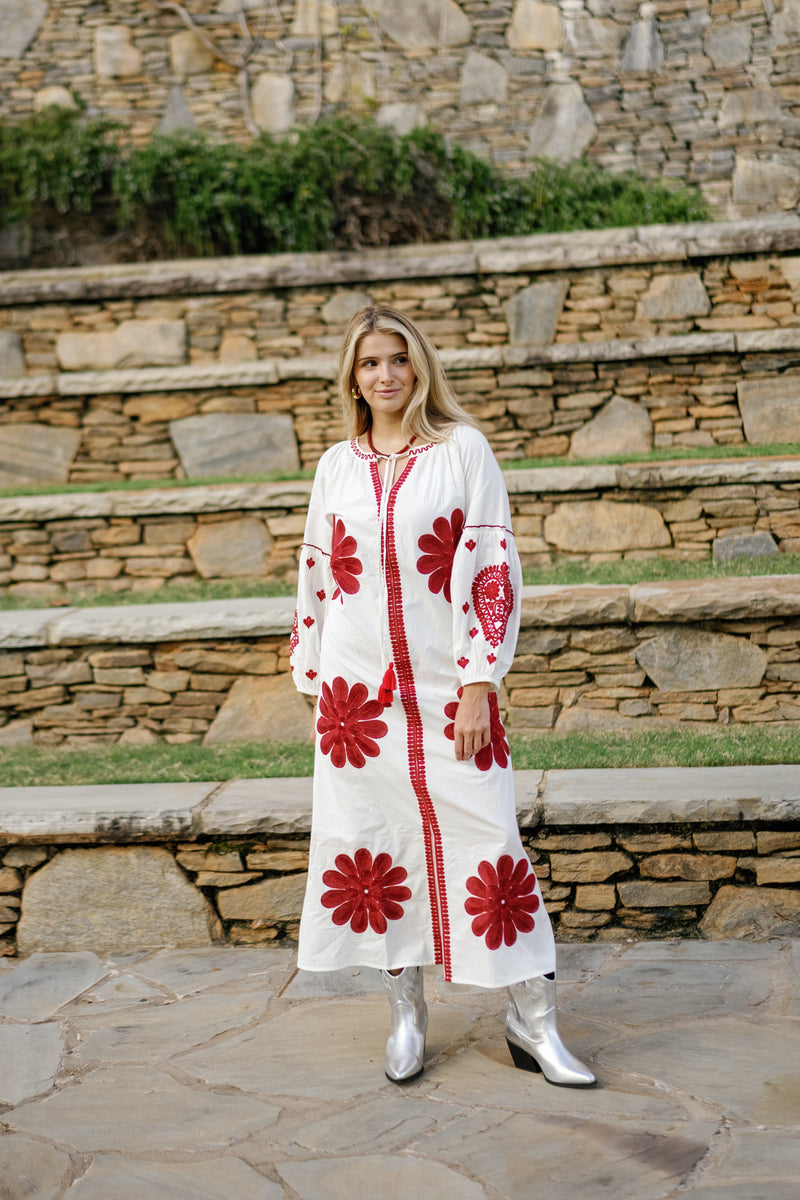 Tela Luxury Mercantile Denny Dress displayed on a hanger, featuring a stylish, flowing design with a soft fabric appearance.