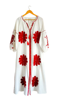 Tela Luxury Mercantile Denny Dress displayed on a hanger, showcasing its elegant fabric and stylish design.