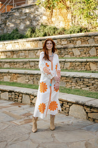 Vibrant orange fabric swatch labeled "Go Orange!" by Tela Luxury Mercantile, showcasing bright, bold textile material.