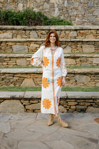 Tela Luxury Mercantile Go Orange! colorful fabric swatch with vibrant orange hues and textured pattern on white background.