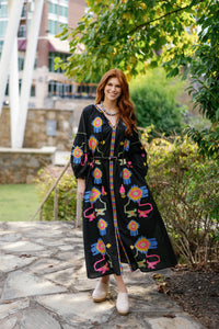 Black Fall Funk sweater by Tela Luxury Mercantile, shown on a model, highlighting its stylish fall-season design and cozy fit.