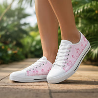 Pink Flamingo low top shoes for women by The Popular Flamingo, showing pink canvas sneakers with white soles and laces.