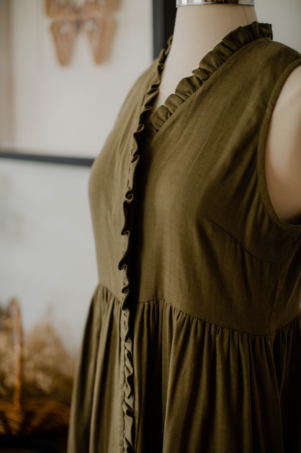 The Village Green house dress displayed on a hanger, featuring a relaxed fit and soft fabric, ideal for comfortable home wear.