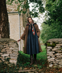 The Village Green house dress featuring a relaxed fit with floral pattern, long sleeves, and knee-length design, ideal for comfortable casual wear.