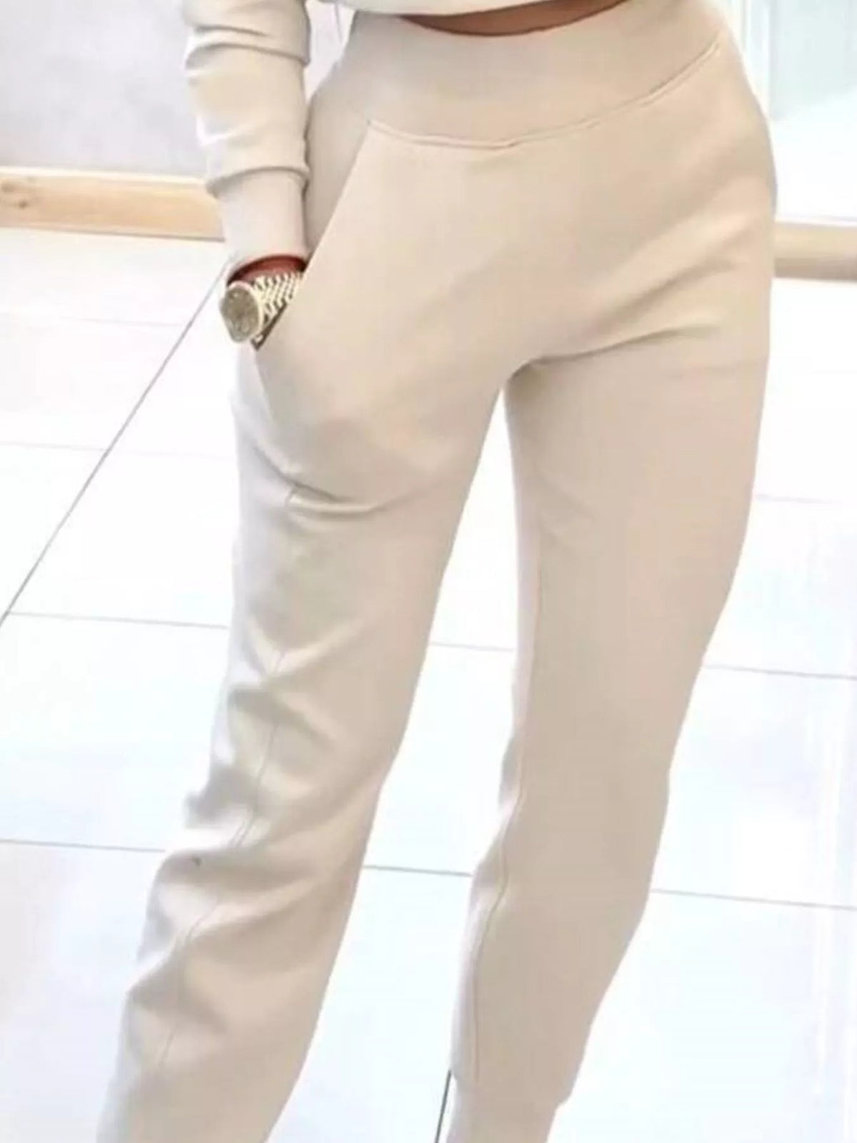 Apricot-colored casual chic cropped sweatshirt and jogger set by Trendsi, featuring comfortable, stylish loungewear with a relaxed fit.