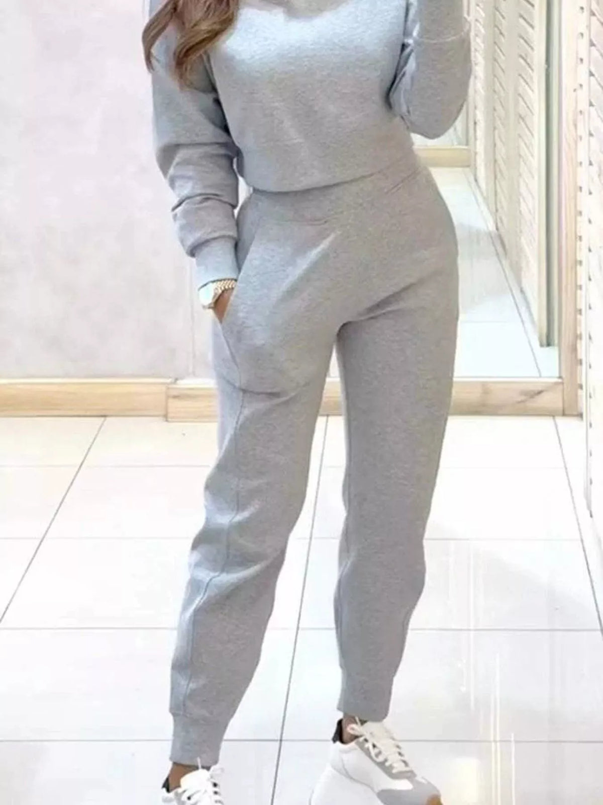 Apricot casual chic cropped sweatshirt and jogger set by Trendsi, featuring a relaxed fit and comfortable fabric for everyday wear.