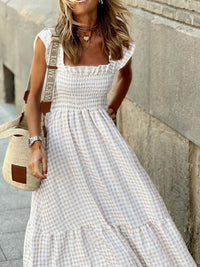Beige plaid maxi dress with ruffle sleeves, stylish and flowing, perfect for casual or semi-formal occasions.