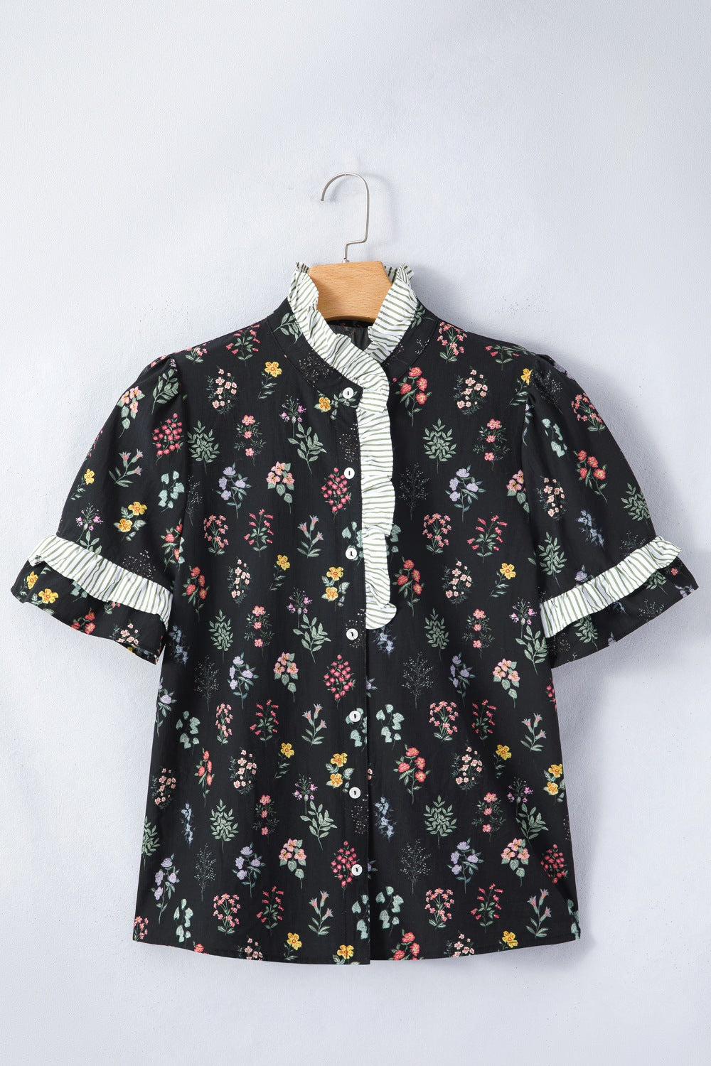 Black floral short sleeve shirt with contrast frilled trim, made by Trendsi, shown with a relaxed fit and vibrant floral pattern.