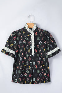 Black floral short sleeve shirt with contrast frilled trim, made by Trendsi, shown with a relaxed fit and vibrant floral pattern.