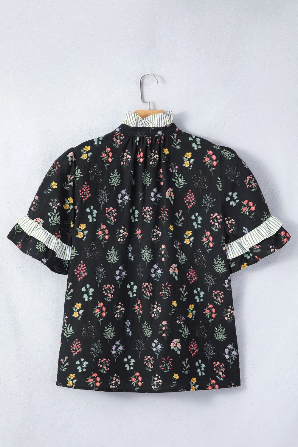 Black floral short sleeve shirt with contrast frilled trim from Trendsi, featuring a stylish, feminine design and lightweight fabric.