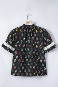 Black floral short sleeve shirt with contrast frilled trim from Trendsi, featuring a stylish, feminine design and lightweight fabric.