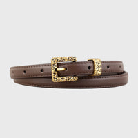 Leather skinny belt with a metal buckle, trendy accessory from Trendsi, featuring a sleek black design and adjustable fit.