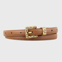 Black skinny leather belt with silver buckle from Trendsi, featuring a sleek, smooth design and adjustable fit.