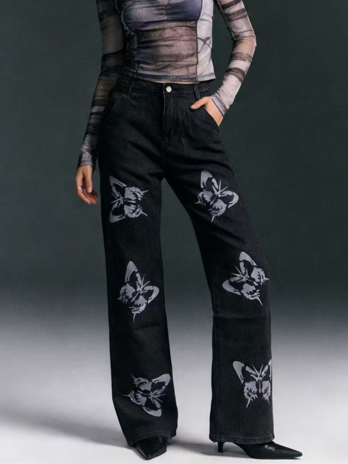Black butterfly print high-waisted wide-leg jeans from Trendsi, showcasing the relaxed fit and stylish butterfly pattern.