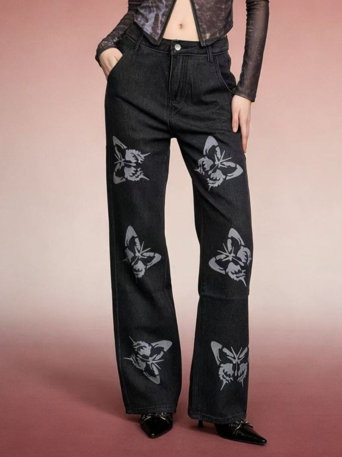 Black butterfly print high-waisted wide-leg jeans from Trendsi, showcasing the floral butterfly pattern and relaxed fit.