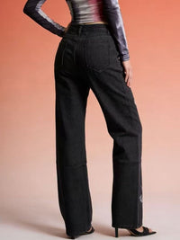Black butterfly print high-waisted wide-leg jeans by Trendsi, featuring a stylish fit and bold floral pattern.