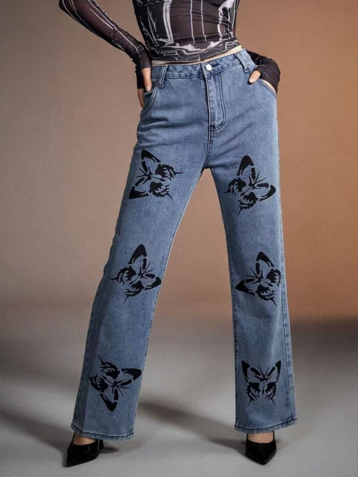 Black butterfly print high-waisted wide-leg jeans by Trendsi, featuring a stylish floral pattern and relaxed fit.