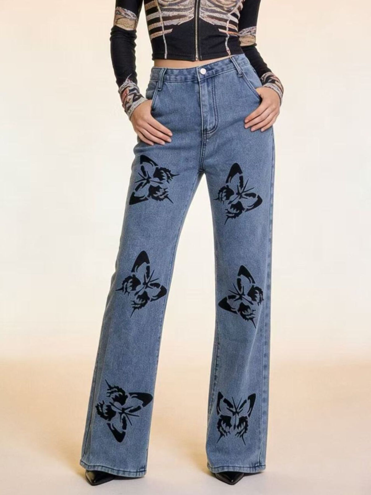 Black butterfly print high-waisted wide-leg jeans from Trendsi, featuring a relaxed fit and stylish floral design.