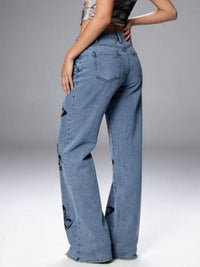 Black butterfly print high-waisted wide-leg jeans by Trendsi, showing the stylish design and relaxed fit.