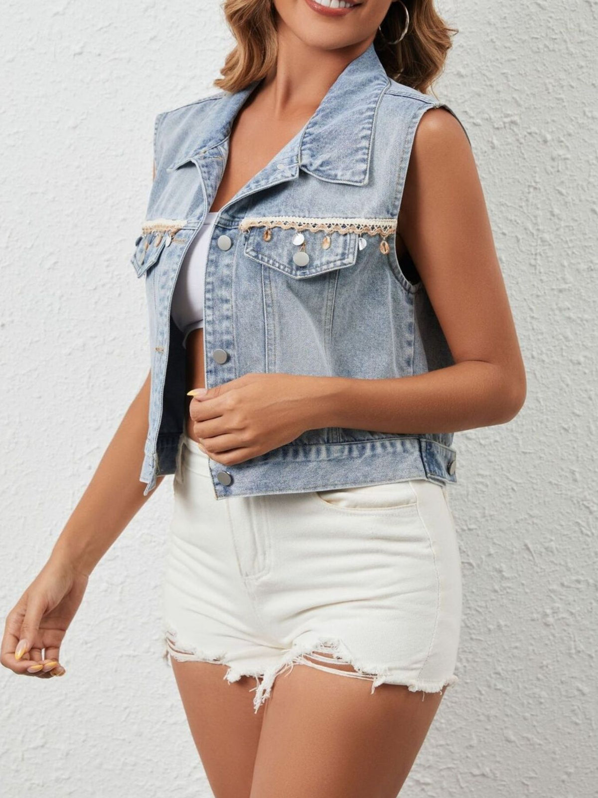 Black button-up denim vest by Trendsi featuring classic collar and sleeveless design, styled with visible stitching and front pockets.