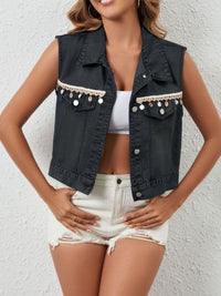 Black button-up denim vest from Trendsi featuring a classic fit and front button closure, styled with casual clothing.