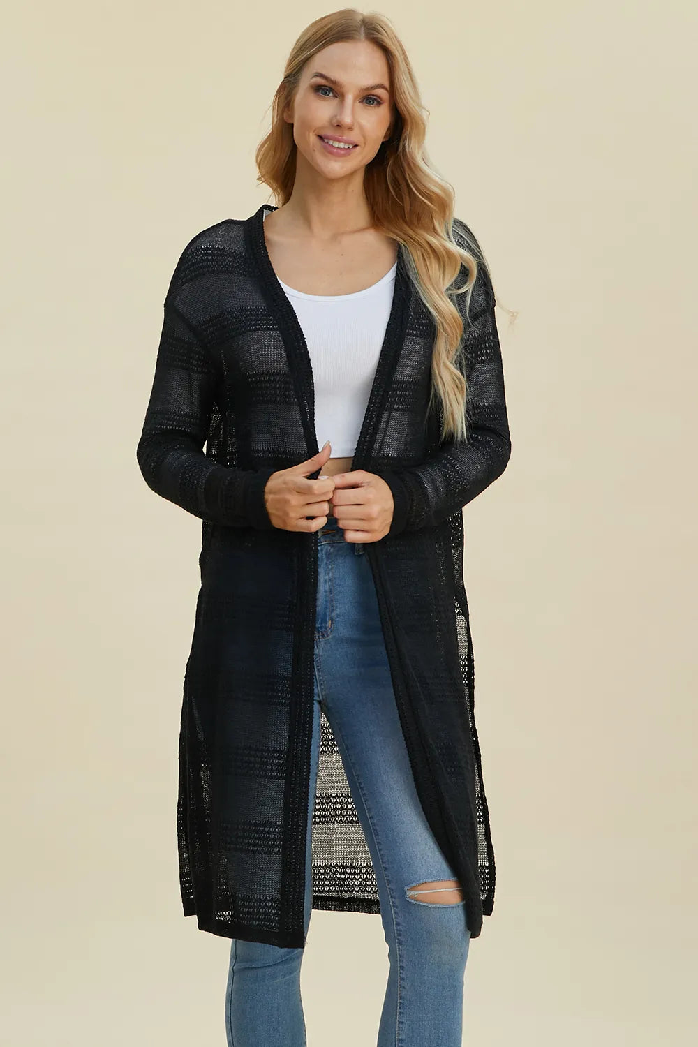 Black Trendsi Double Take full-size open front longline cardigan displayed hanging on a clothing rack.
