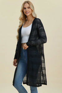 Black Trendsi Double Take full size open front longline cardigan hanging on a clothing rack.