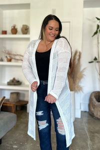 Black Trendsi Double Take full-size open front longline cardigan displayed hanging with a relaxed fit and open front design.