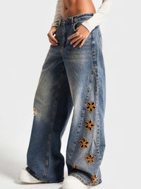 Blue floral embroidered wide leg jeans from Trendsi, featuring intricate flower patterns and a relaxed, wide-leg fit.