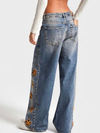 Blue floral embroidered wide leg jeans from Trendsi, featuring detailed embroidery and relaxed fit.