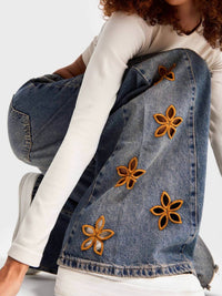 Blue floral embroidered wide-leg jeans by Trendsi, featuring intricate embroidery and a relaxed fit, displayed on a plain background.