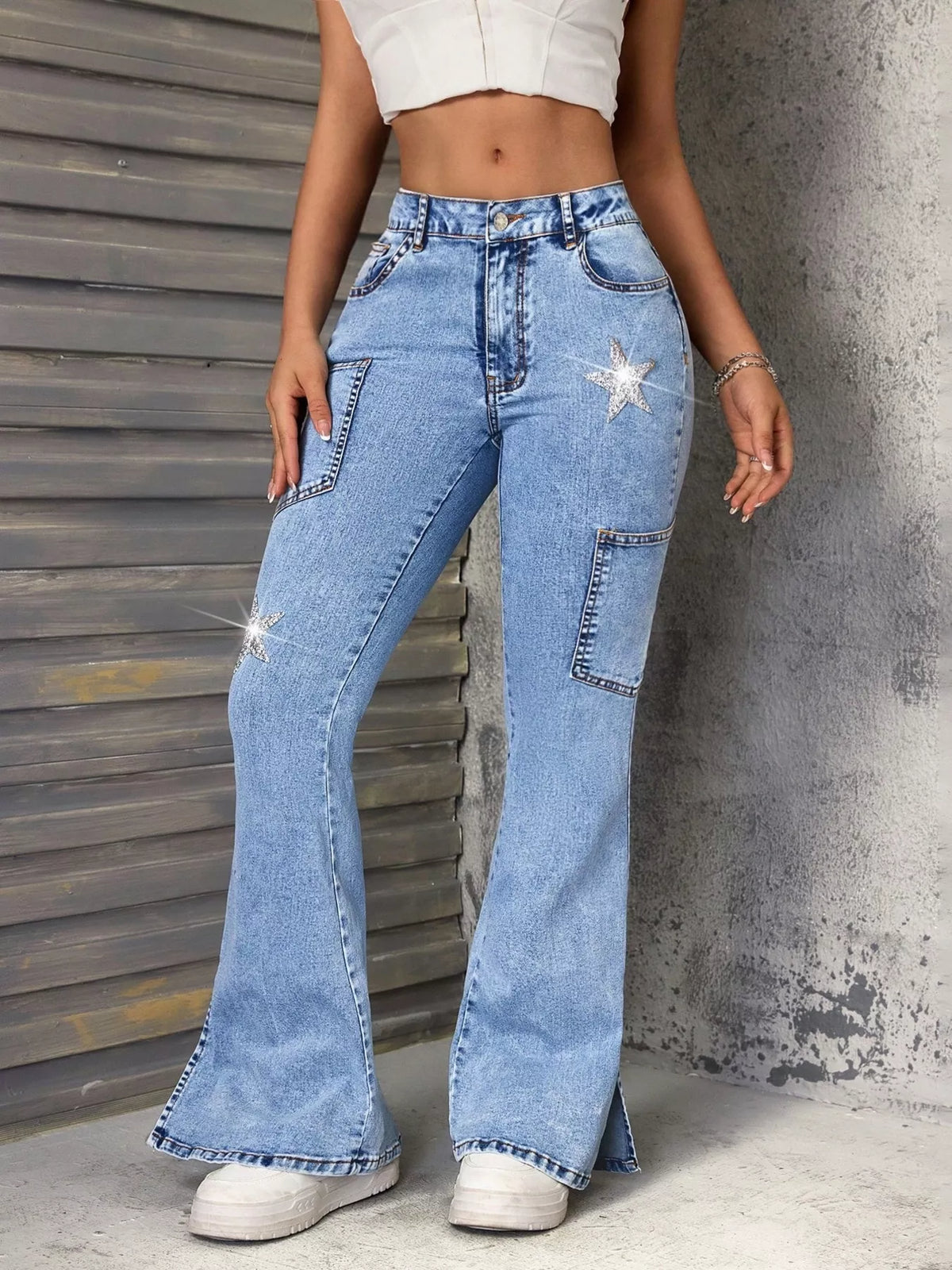 Blue slit star flare leg jeans by Trendsi featuring a stylish star pattern and flared silhouette, shown on a model.