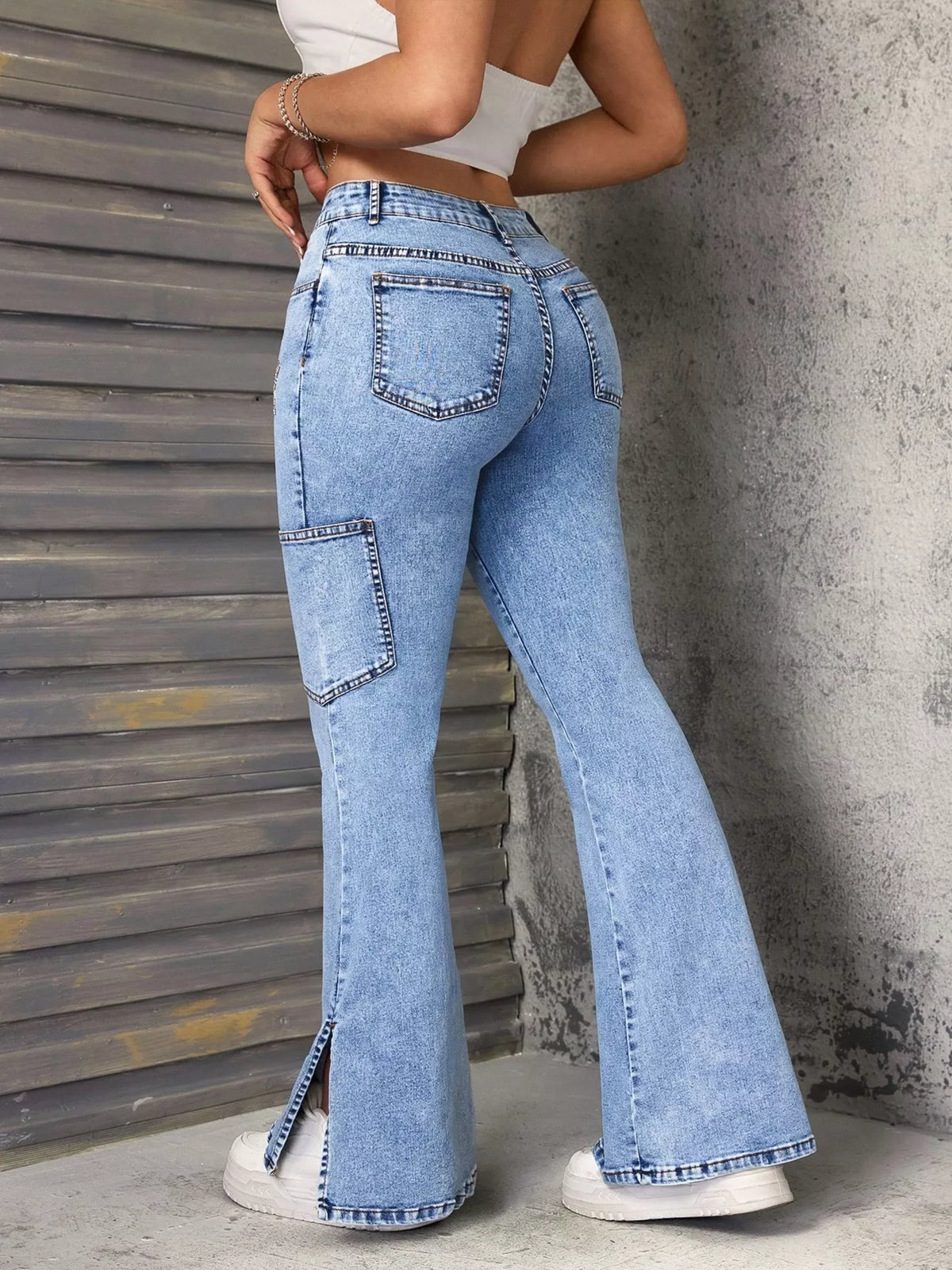 Trendsi blue slit star flare leg jeans with high waist, featuring side slits and star embroidery on the legs.
