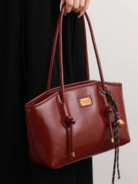 Leather shoulder bag with knot detail from Trendsi, featuring a stylish design and adjustable strap in a natural leather finish.