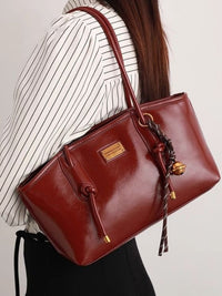 Leather shoulder bag with knot detail from Trendsi, featuring a stylish design and soft texture.