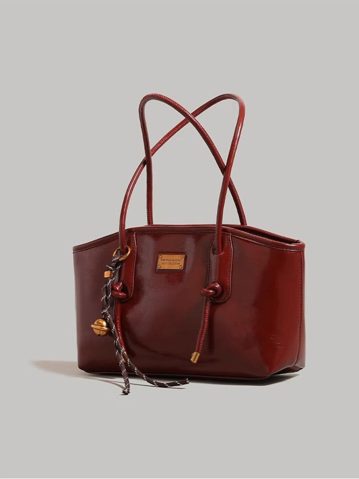 Leather shoulder bag with knot detail, Trendsi brand, featuring a sleek design and adjustable strap.