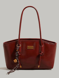 Leather shoulder bag with knot detail from Trendsi, featuring a stylish design and adjustable strap on a neutral background.