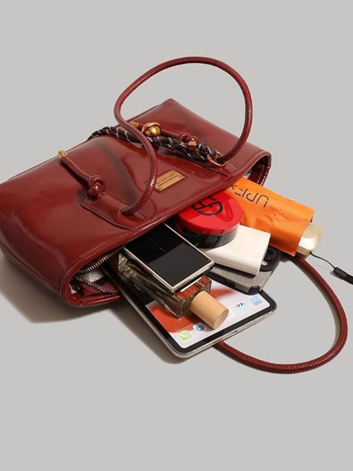 Leather shoulder bag with knot detail by Trendsi, featuring a sleek design and adjustable strap for stylish everyday use.