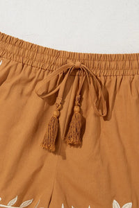 Embroidered boho casual shorts with tasseled drawstring and elastic waist in caramel color, featuring intricate embroidery details.