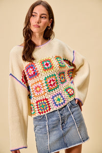 Multi-color granny crochet lace sweater top by Trendsi, featuring intricate crochet details and a relaxed fit in vibrant hues.