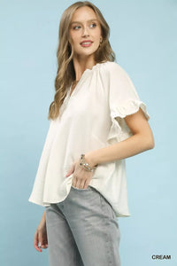 Umgee Ruffle Sleeve V-Neck Flutter Blouse featuring soft fabric, ruffle sleeves, and a stylish V-neck design.