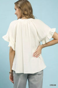 Umgee ruffle sleeve V-neck flutter blouse featuring soft fabric and feminine ruffle details, perfect for casual or dressy wear.