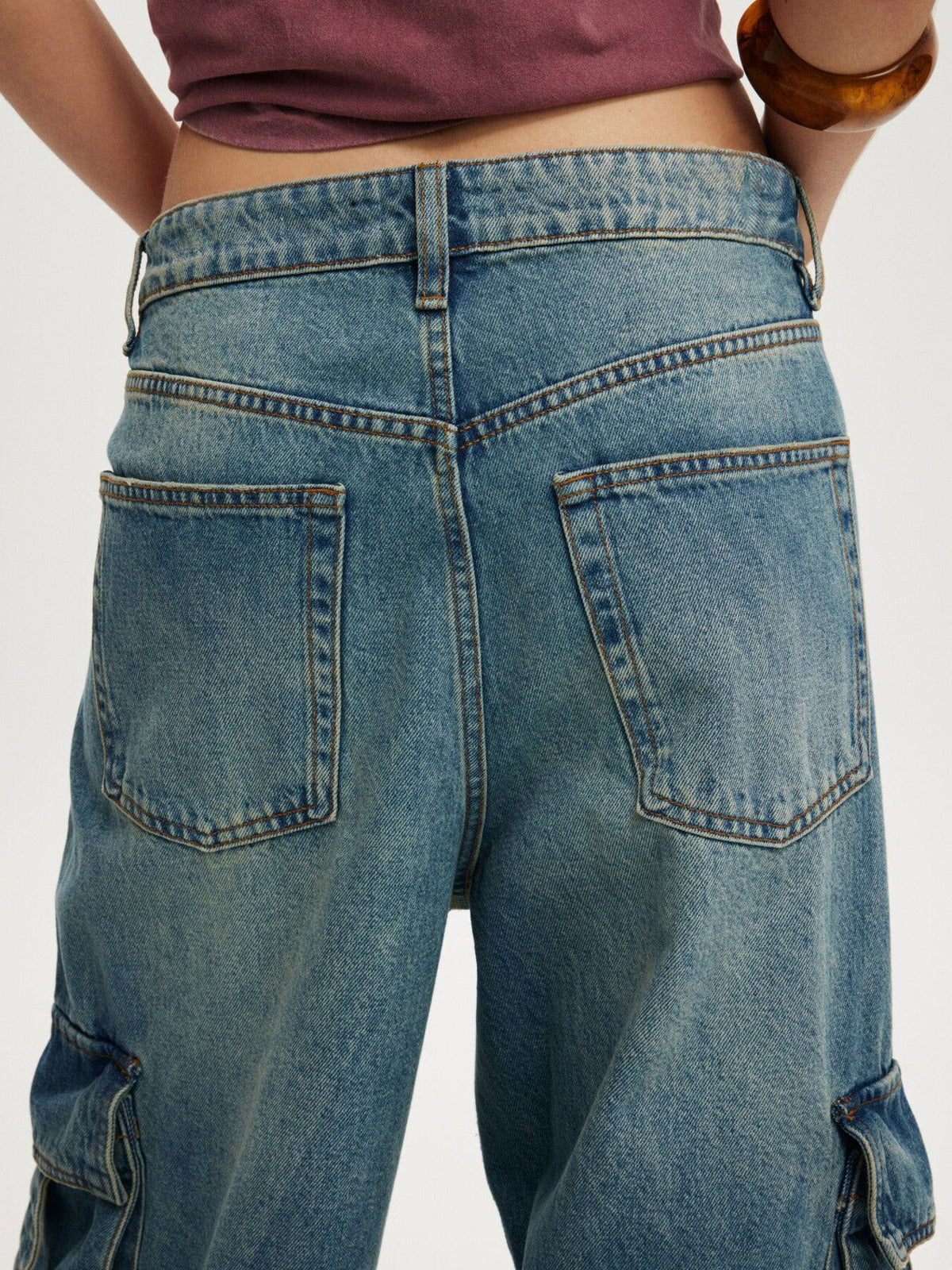 Vintage wash wide leg cargo jeans from Trendsi, showing relaxed fit, multiple pockets, and faded denim texture.